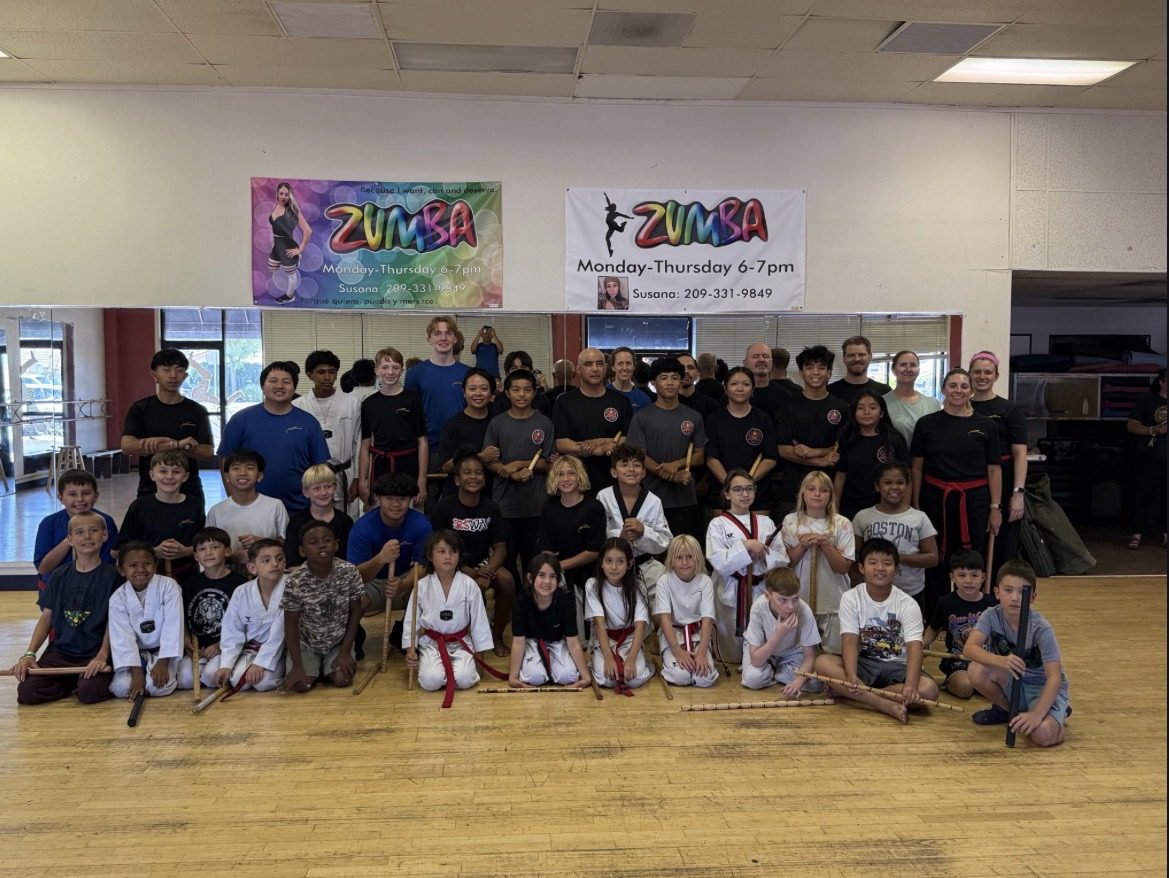 Large group of youth and adult Escrima students with training sticks at Cutting Edge Martial Arts in Lodi